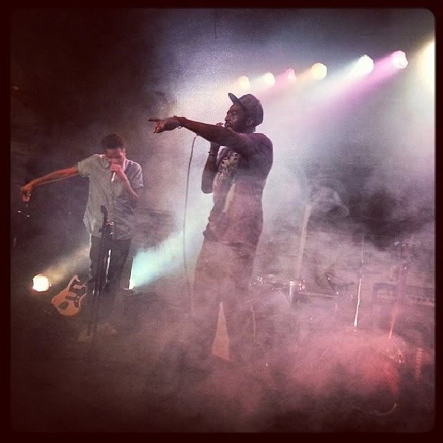 Tripoli performing on stage with a microphone