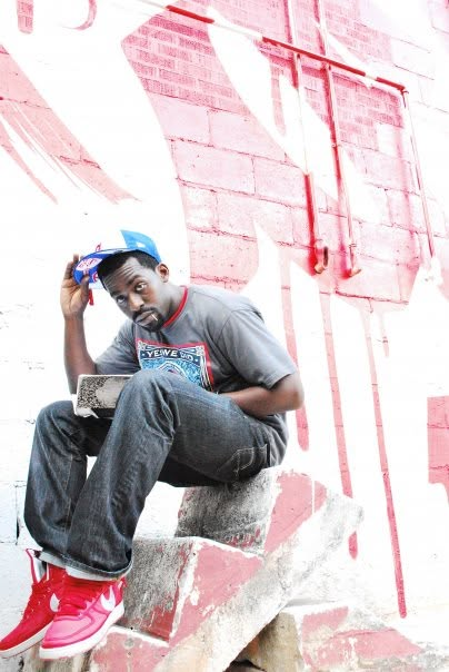 Tripoli sitting on concrete stairs with a book