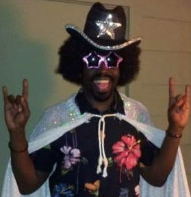 Tripoli in a cowboy hat, cape and star-shaped glasses